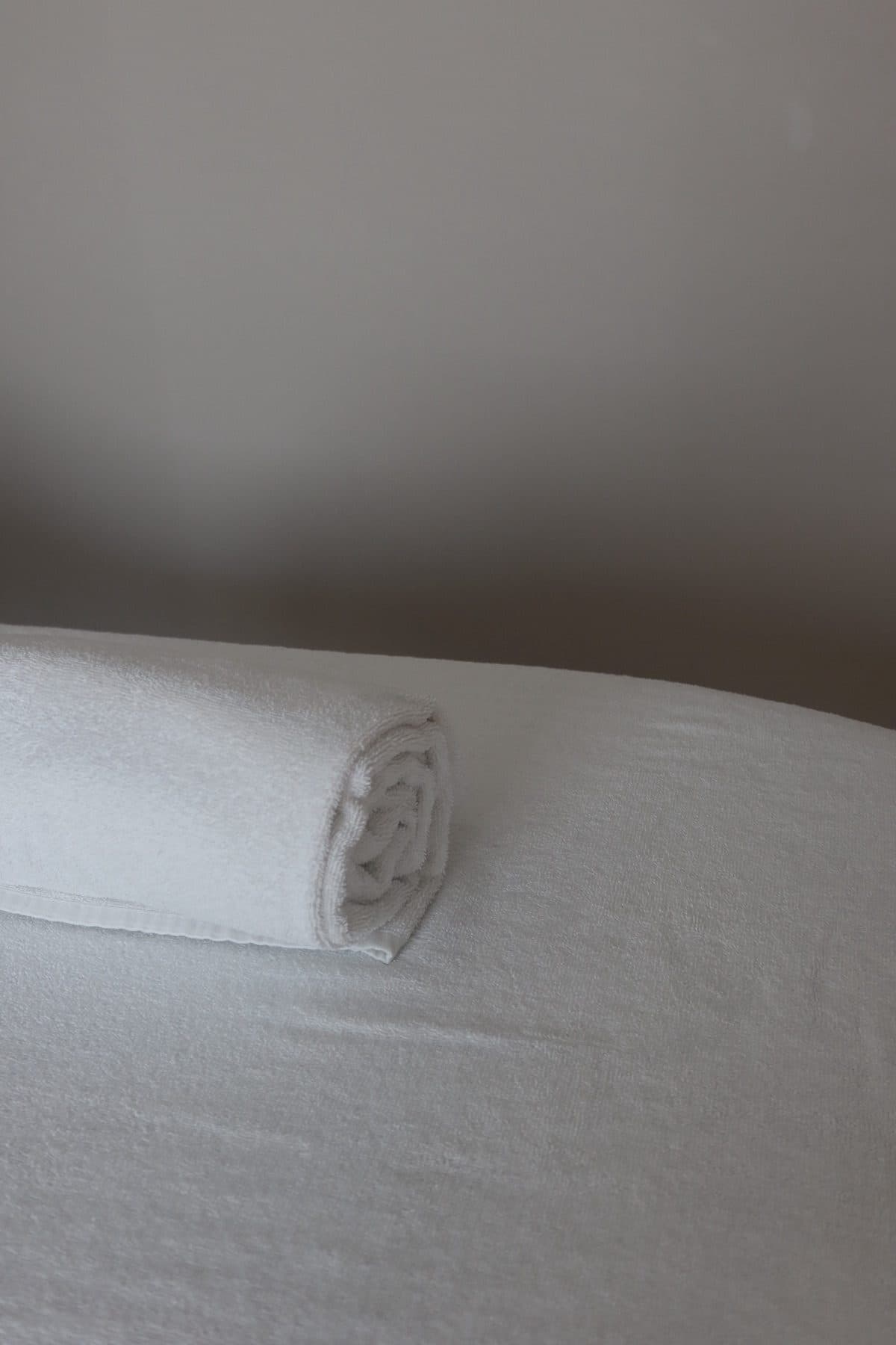 The massage table made up with fresh linen in the treatment room.